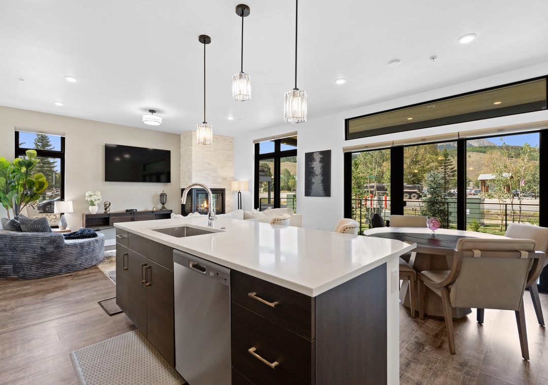 A bright, contemporary open-concept space where your kitchen flows seamlessly into living and dining areas. Sleek pendant lighting, a spacious island, and large windows framing tranquil outdoor views make this the perfect gathering spot.