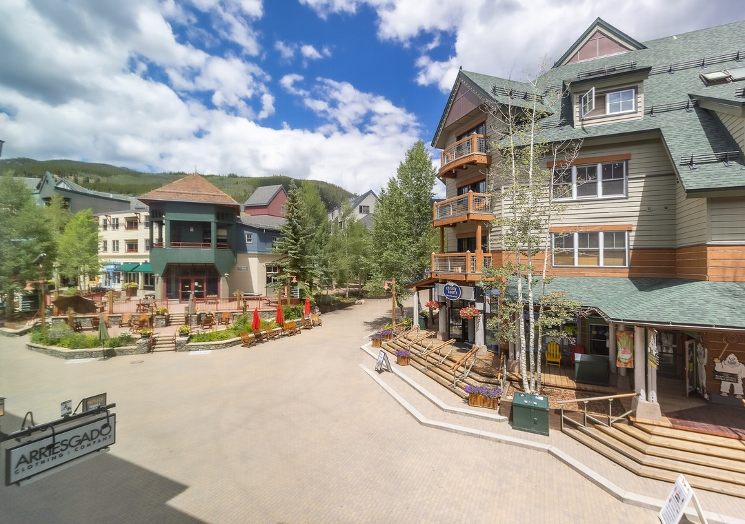 Charming village setting nestled among forested mountains, featuring colorful alpine-style buildings and pedestrian-friendly streets perfect for exploring local shops and restaurants.