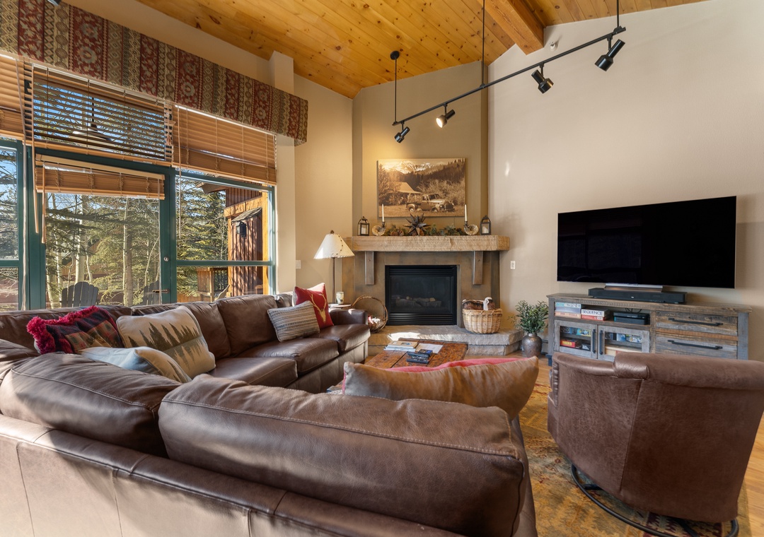 Sink into plush leather seating by your crackling fireplace, where exposed beams create mountain lodge charm.
