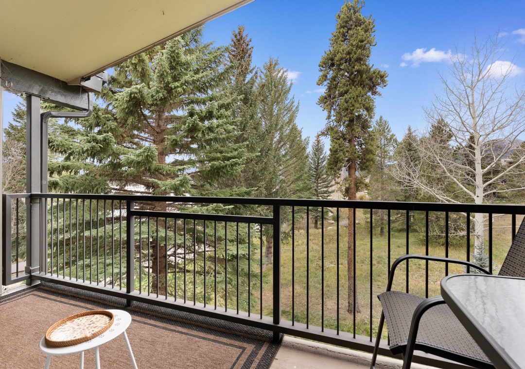 A peaceful treetop retreat awaits. Your private balcony overlooks serene greenery and towering pines, perfect for morning coffee or evening unwinding in the fresh mountain air.