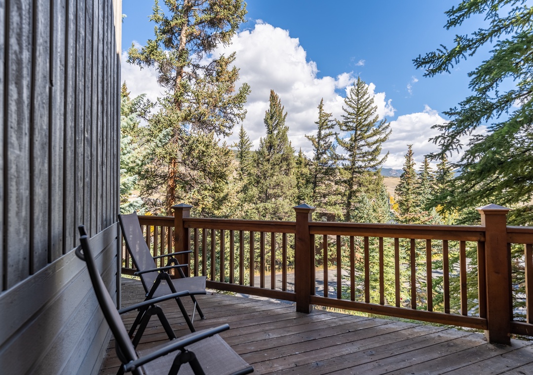 Settle into your private balcony chairs and breathe in the fresh mountain air while towering evergreens frame your peaceful forest retreat.