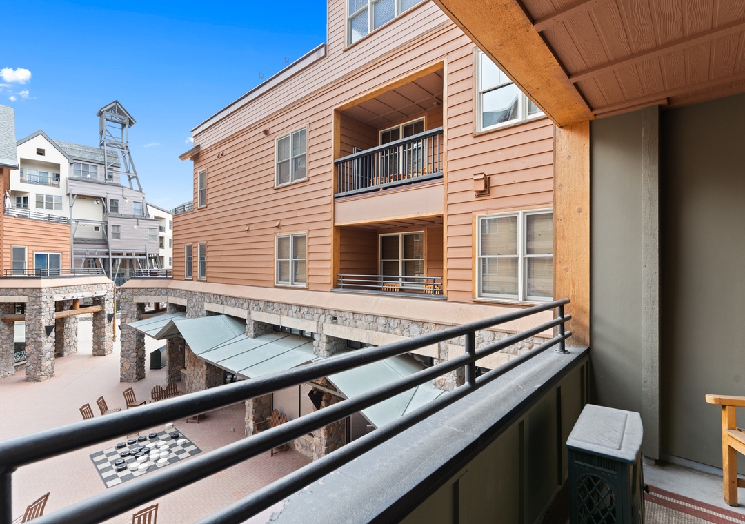 Overlooking a lively courtyard and alpine architecture, this private balcony gives you a front-row seat to the mountain village atmosphere below.