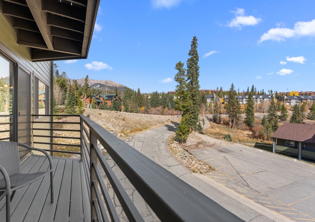 A private balcony offering mountain views and fresh alpine air, with a comfortable chair positioned to take in the peaceful natural scenery surrounding the property.