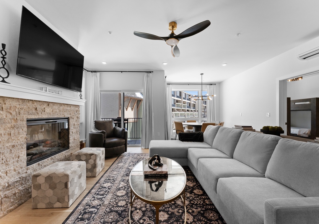Sink into your plush sectional and enjoy evenings by the fireplace in this stylish living space with modern comforts.