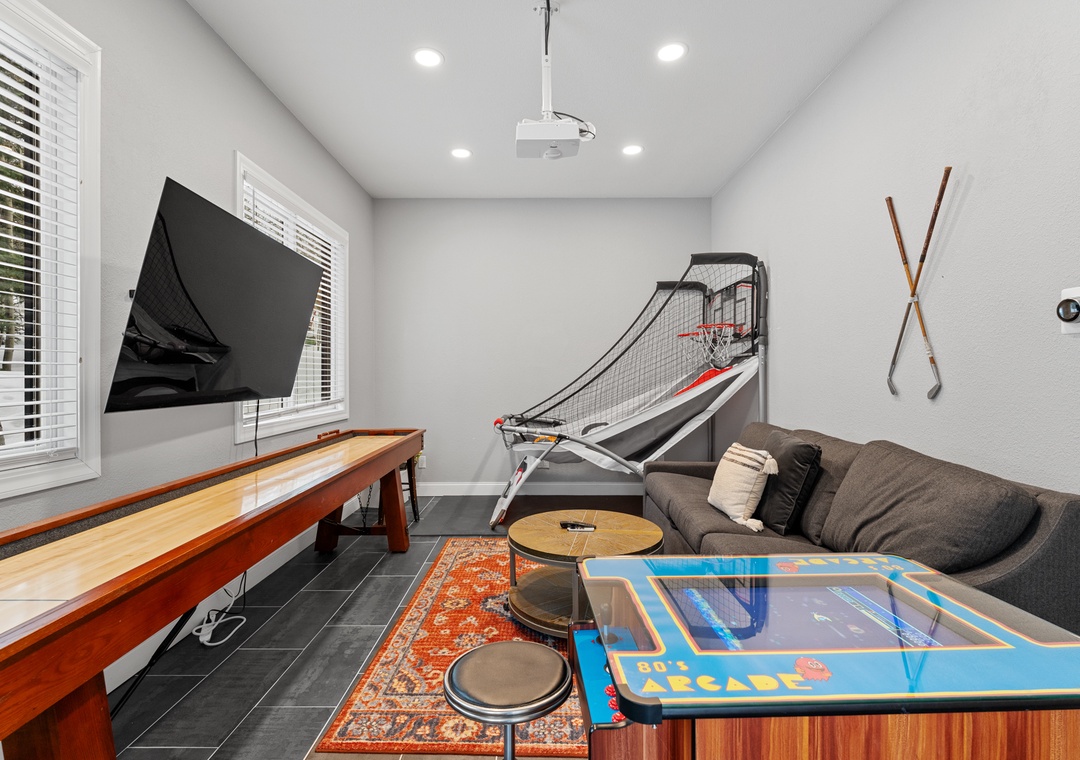 Your private game room awaits with basketball, arcade fun, and cozy seating for endless entertainment.