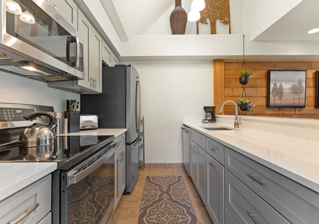 Your fully equipped kitchen features sleek countertops, modern appliances, and warm wood accents—perfect for preparing meals at your own pace during your stay.