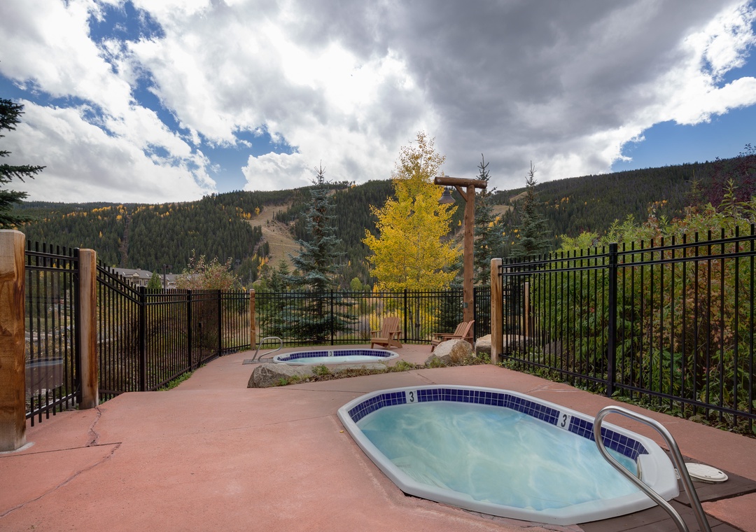 Soak in the hot tub while taking in stunning mountain views surrounded by golden autumn foliage and forest-covered peaks.