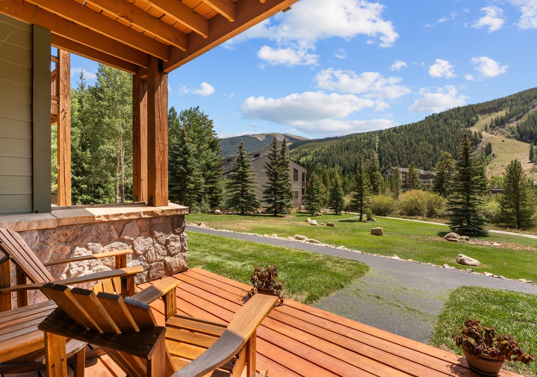 Settle into your private patio with sweeping mountain views, where wooden Adirondack chairs invite you to sip morning coffee or unwind after a day of adventure surrounded by towering pines and alpine peaks.