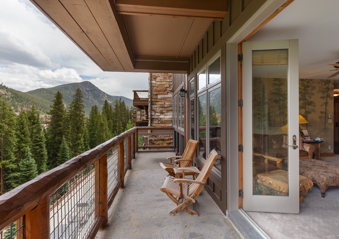 Relax on your private terrace with stunning mountain views, where wooden chairs await your morning coffee moments.