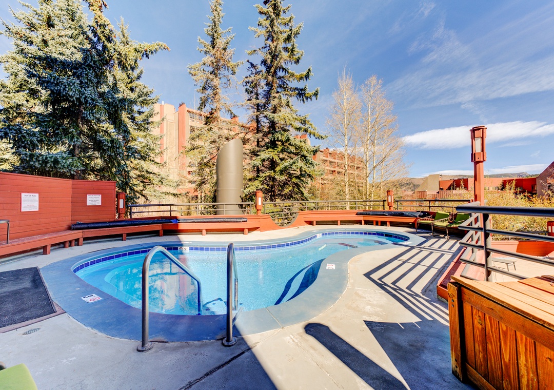Rooftop pool and hot tub area with mountain views and resort amenities.