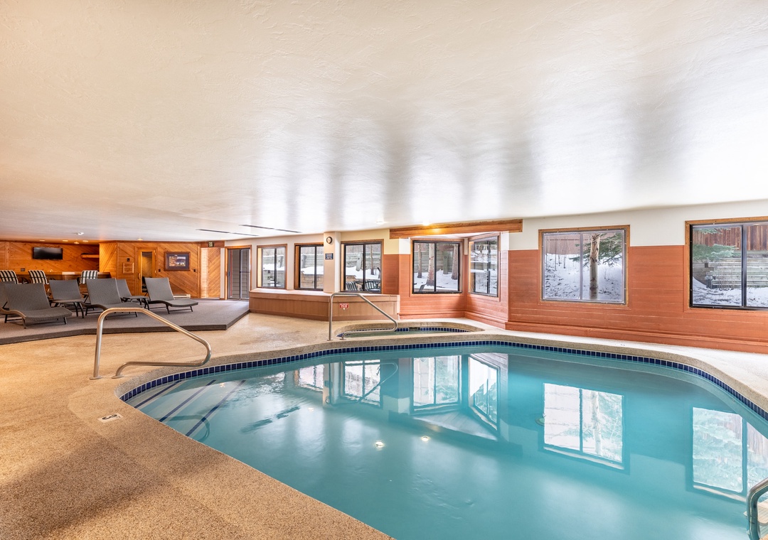 Dive into crystal-clear waters in your private indoor pool area, complete with comfortable lounge chairs for post-swim relaxation.