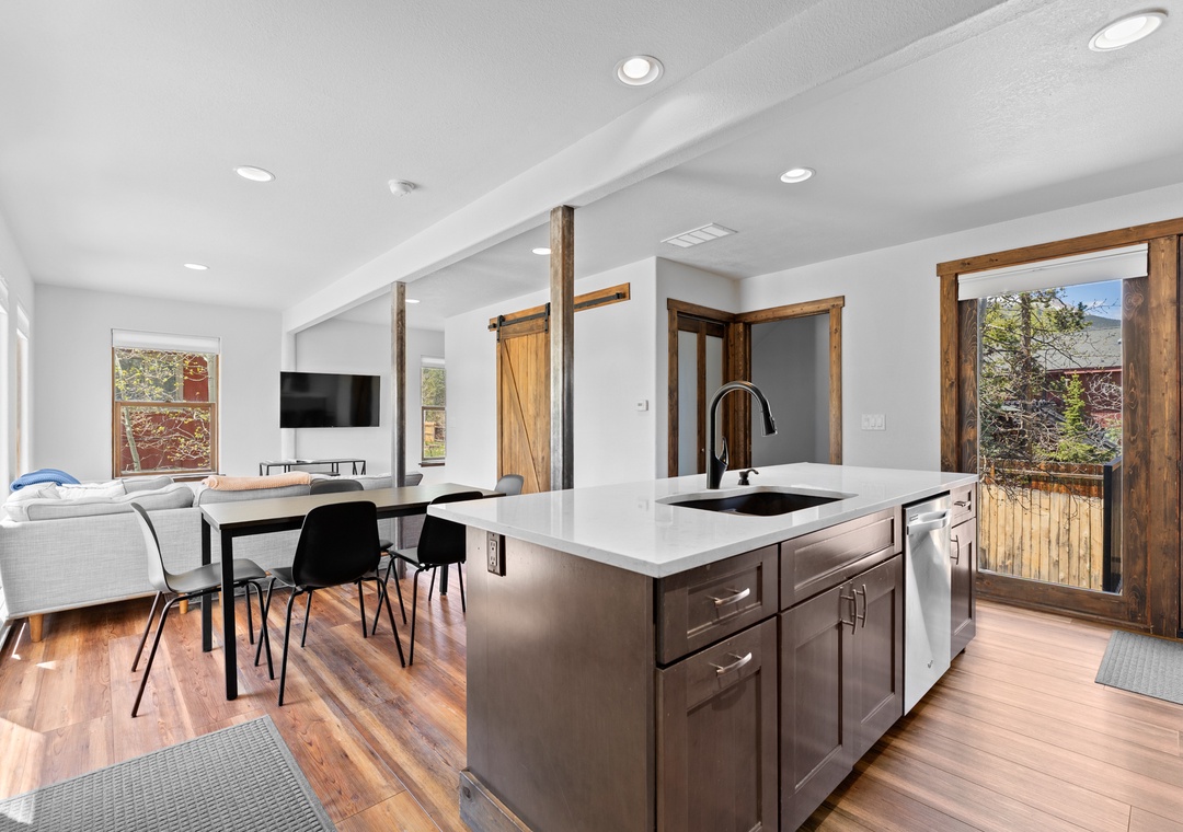 A bright, open-concept space where your vacation unfolds—cook, dine, and unwind all in one inviting area with mountain views just beyond the door.