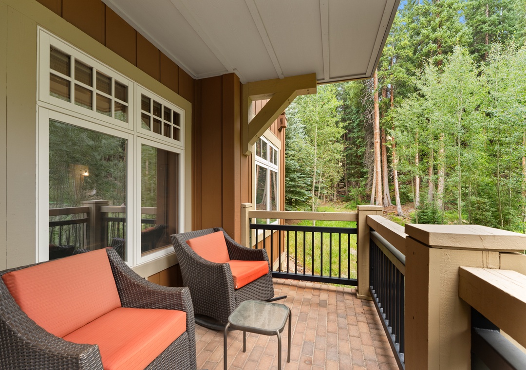 Unwind on your private balcony with comfortable seating and serene forest views—your perfect spot for morning coffee or evening relaxation.