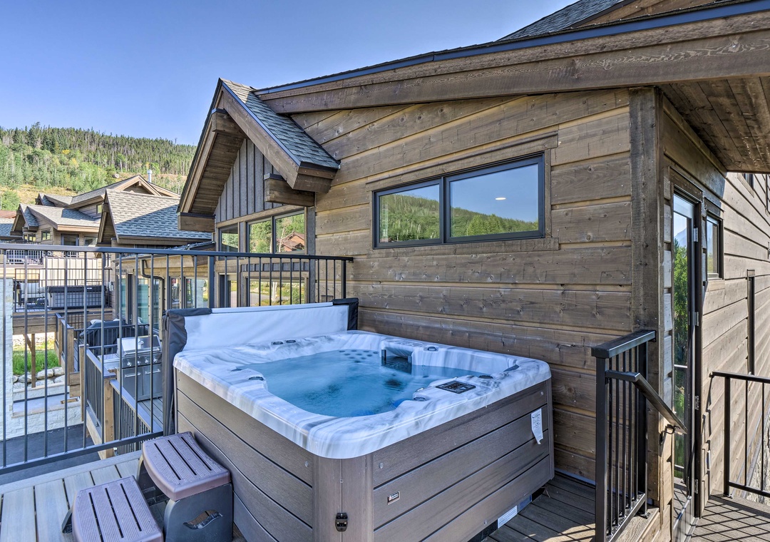 Soak in your private hot tub on this mountain deck, where warm bubbles meet cool forest air for pure relaxation.