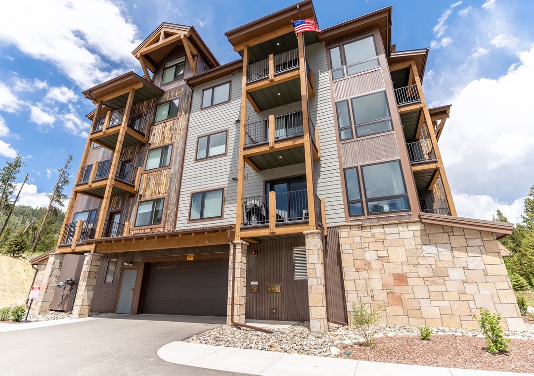 Modern mountain retreat with stone and timber exterior, featuring private balconies and scenic surroundings for memorable getaway.