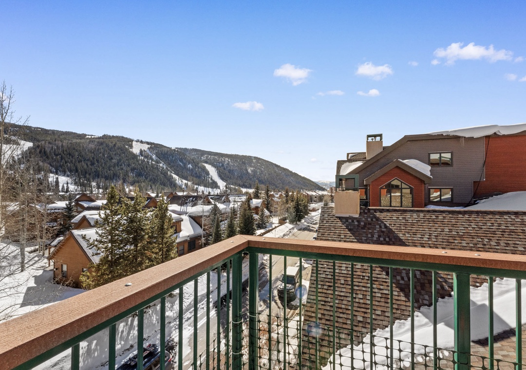 A winter resort area surrounded by snow-covered mountains and ski slopes, offering access to winter sports and alpine scenery.