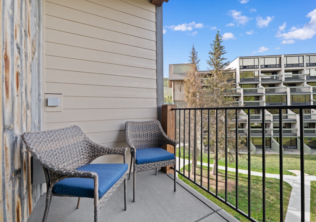 Private balcony featuring comfortable seating and mountain views—ideal for your morning coffee or evening unwind.