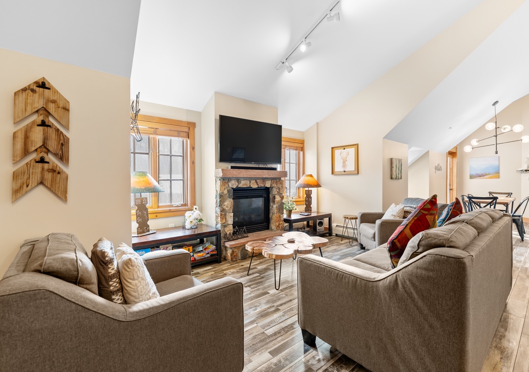 Cozy up in your spacious living room with plush sofas, crackling fireplace, and entertainment center for perfect mountain evenings.