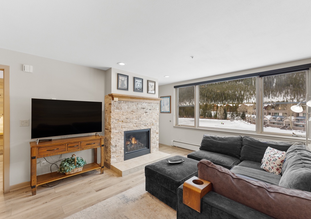 Cozy up by your fireplace while enjoying stunning mountain views from your living room's floor-to-ceiling windows.