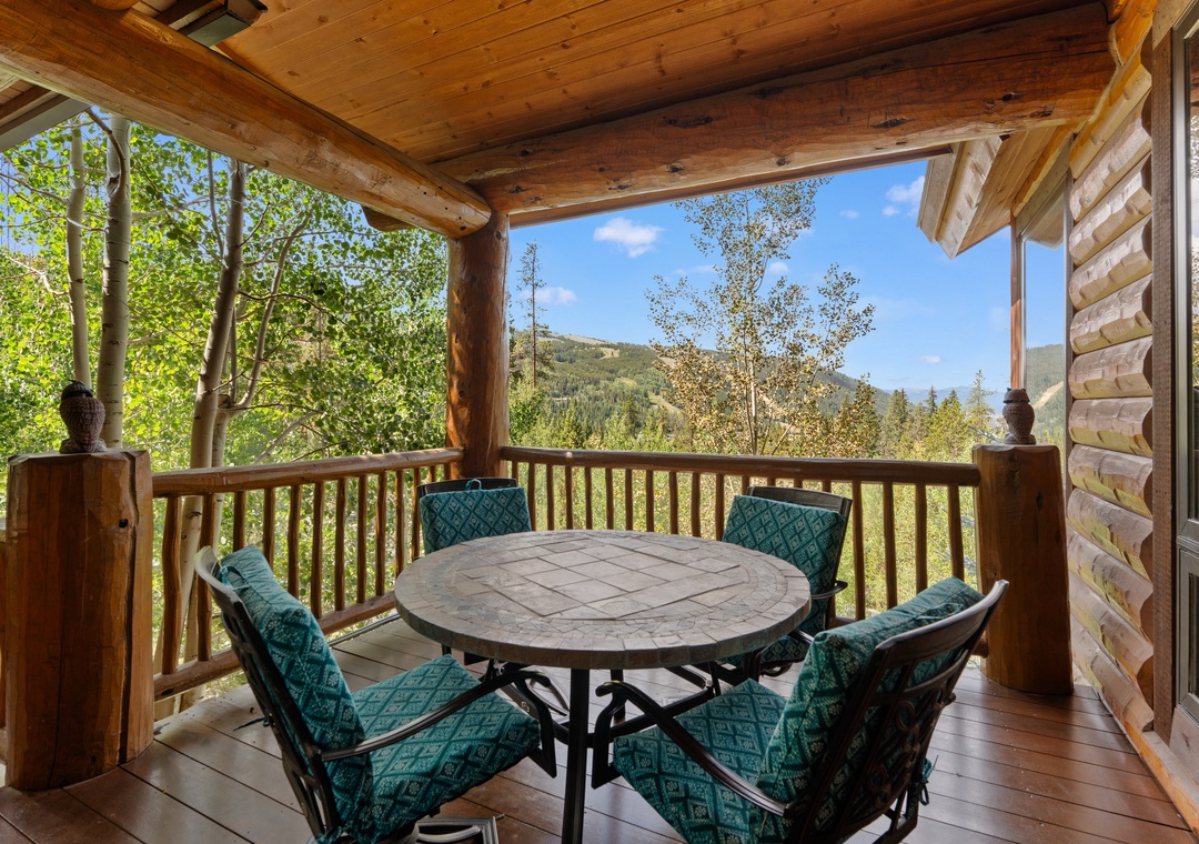 Step onto your private covered deck, where a cozy dining spot awaits surrounded by towering aspens and mountain views. Enjoy morning coffee or evening meals while soaking in the peaceful scenery.