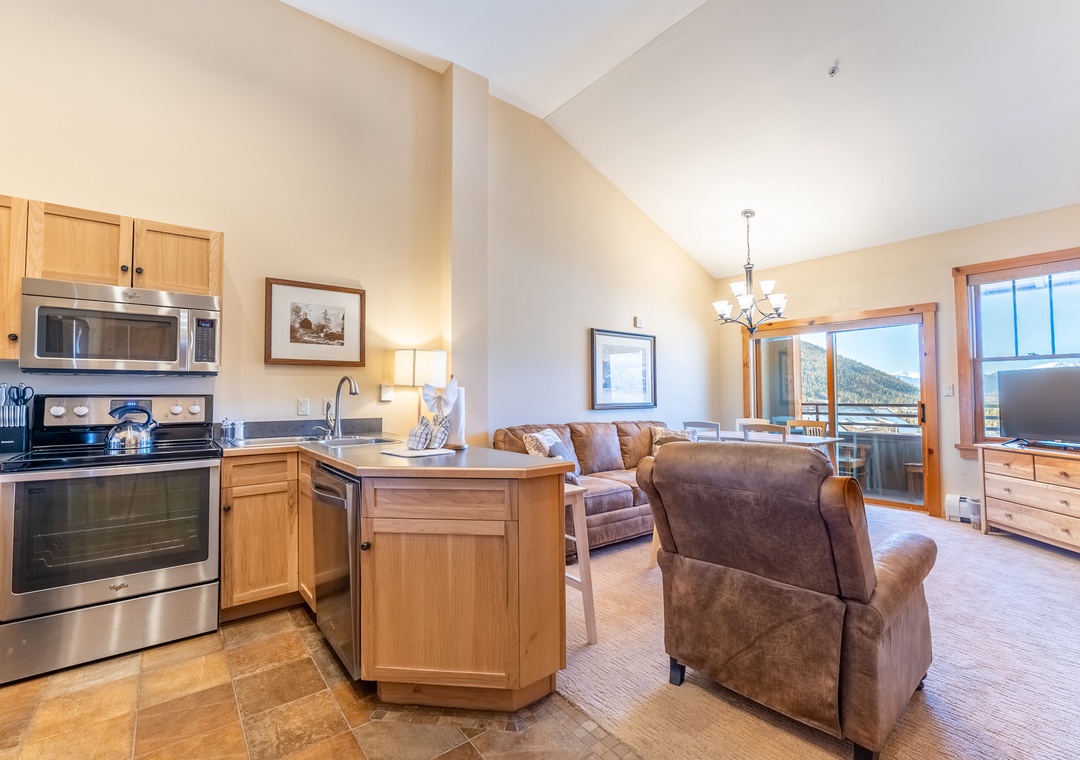 Relax in your spacious open-plan suite with full kitchen, cozy living area, and stunning mountain views from your private balcony.