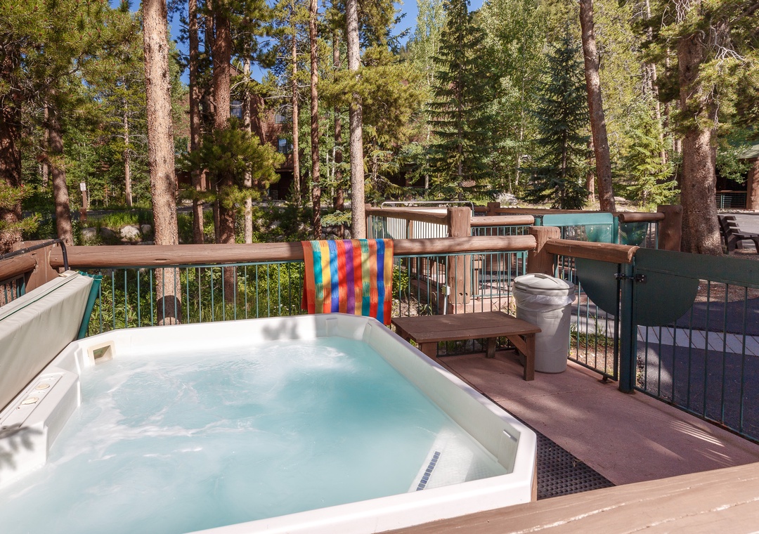 Relax in your private hot tub surrounded by towering pines, with forest views stretching endlessly beyond your peaceful mountain retreat.