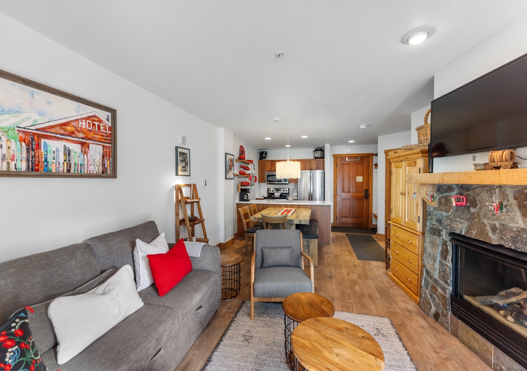 Cozy up in your mountain retreat with a warm fireplace, modern kitchen, and stylish furnishings creating the perfect alpine getaway.