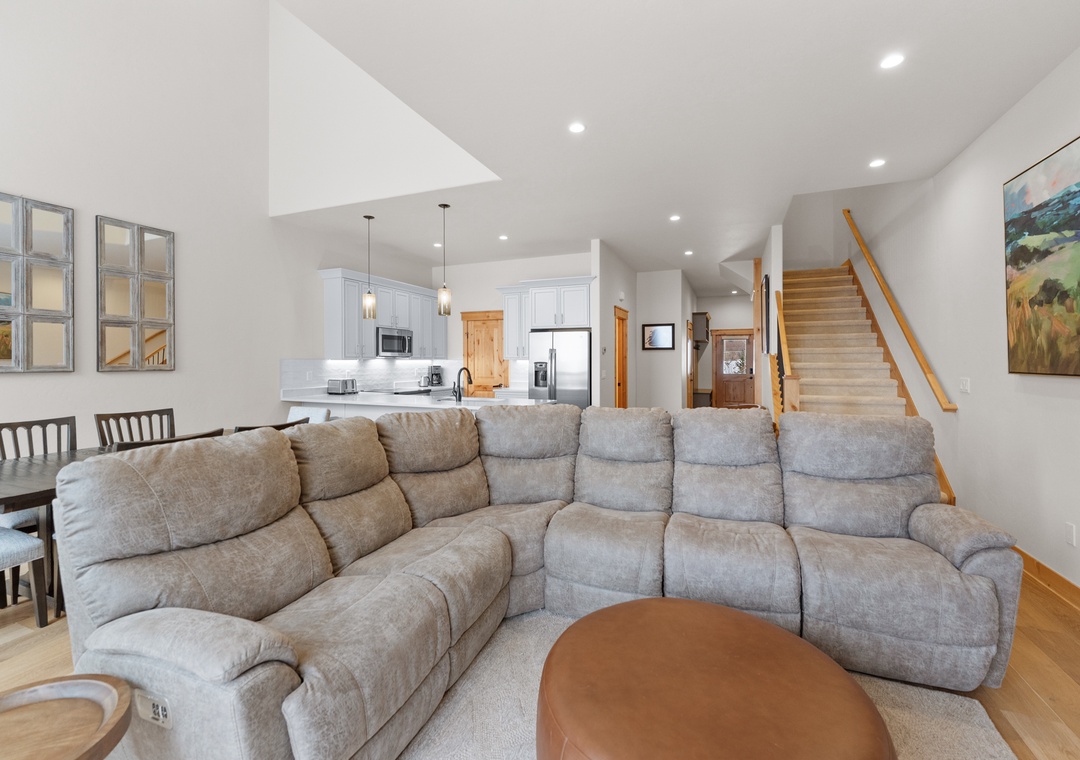 Sink into your spacious sectional sofa in this bright, open-plan living space where modern comfort meets mountain charm perfectly.