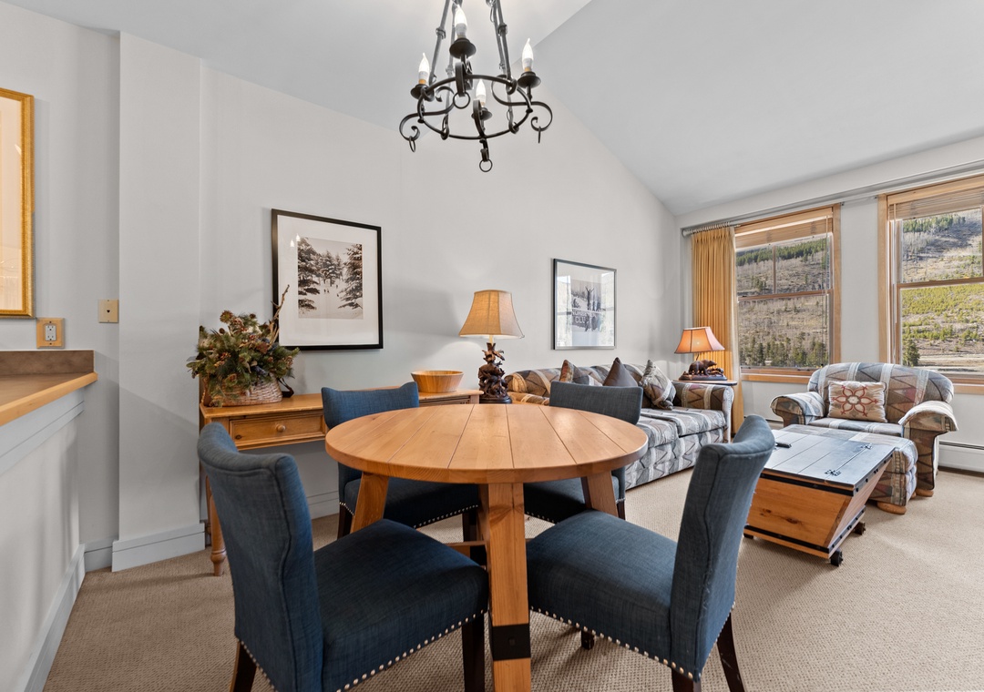 Unwind in this cozy open-concept space where your dining and living areas blend seamlessly. Enjoy mountain views from the windows, gather around the rustic table, and sink into the comfortable seating after a day of adventure.