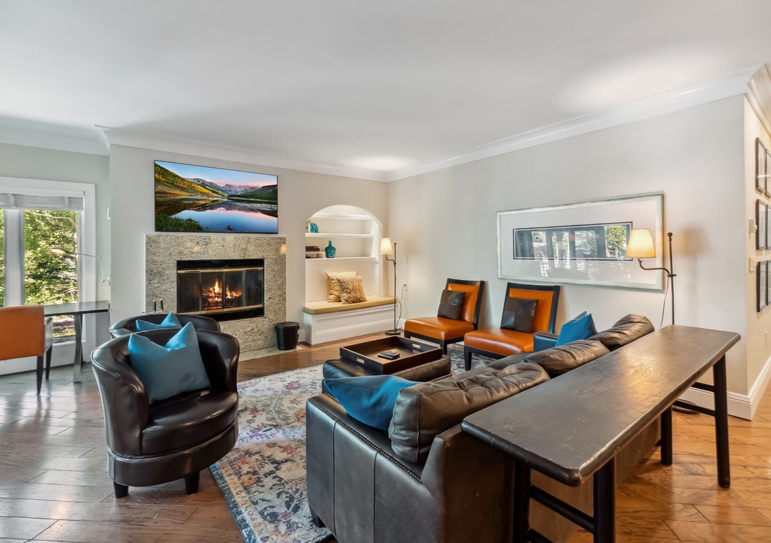 Your elegant living room combines warmth and sophistication with leather seating, crackling fireplace, and thoughtful touches throughout.