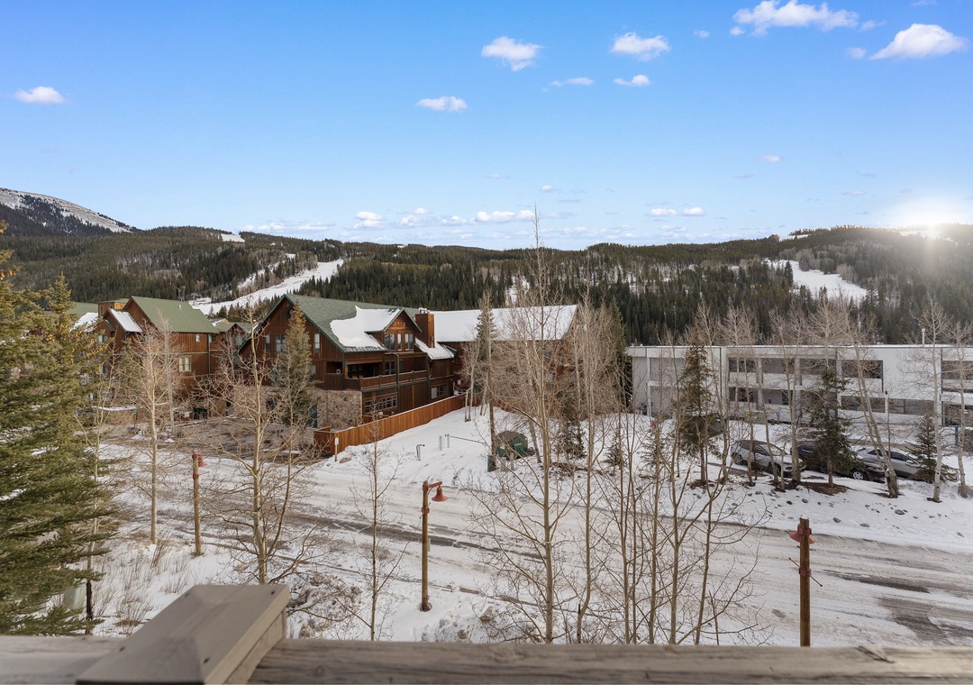 Stunning mountain resort nestled among snow-covered peaks and evergreen forests, with convenient parking and easy access to winter adventures.