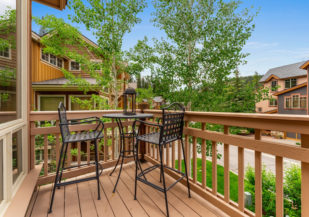 Sip your morning coffee on this peaceful balcony, overlooking lush greenery and charming neighborhood views that create the perfect retreat.