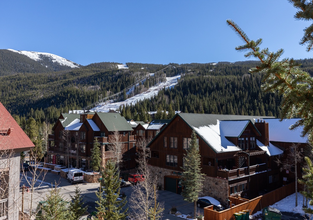 Mountain resort village nestled beneath snow-covered peaks and ski slopes, offering alpine charm and winter recreation access.