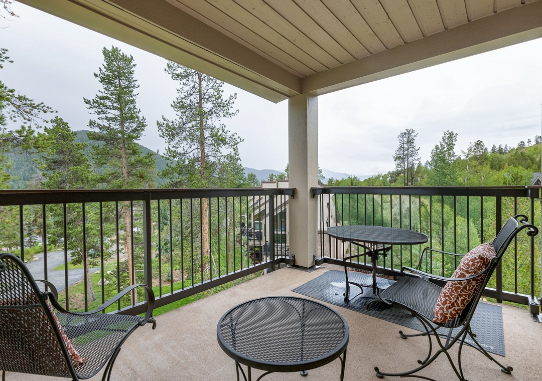 Step onto your private covered balcony and breathe in the mountain air while enjoying serene forest views from your comfortable seating area.