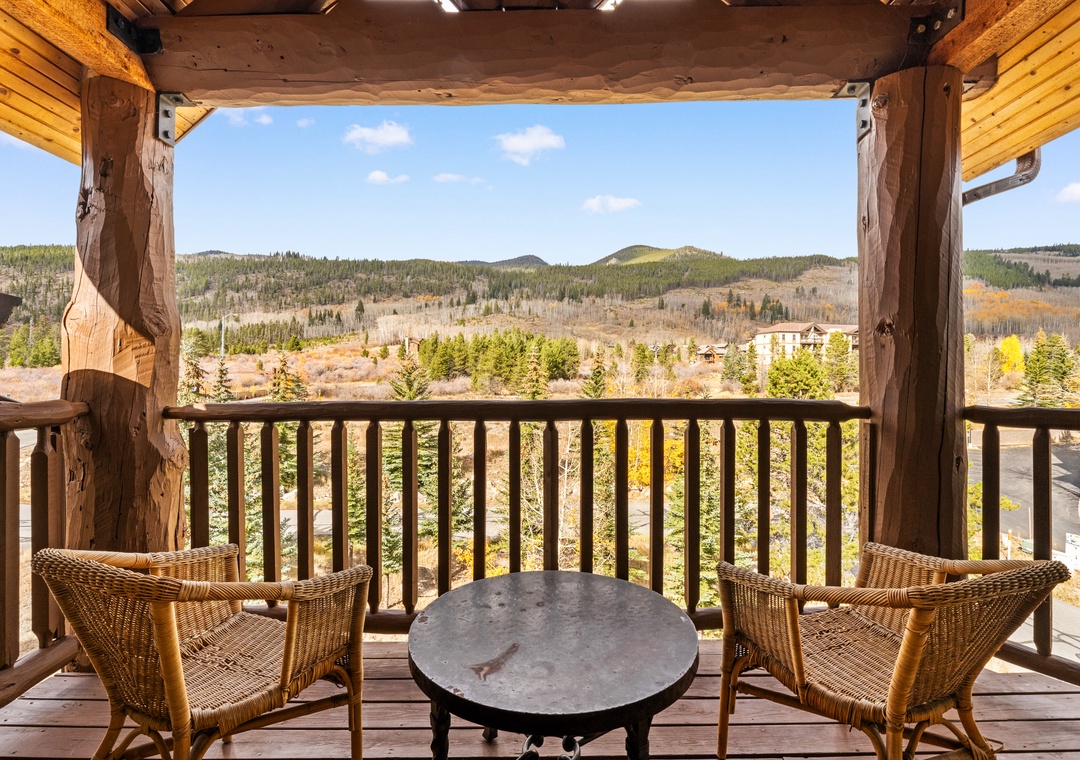 Unwind on your private balcony with wicker seating, savoring panoramic mountain views and fall foliage from this peaceful retreat.