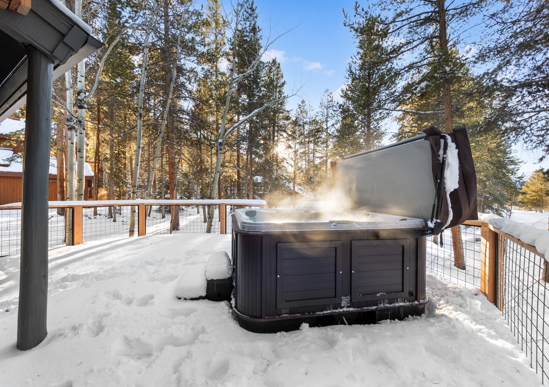 Soak in your private hot tub surrounded by snow-covered pines, steam rising as you enjoy the crisp winter air.