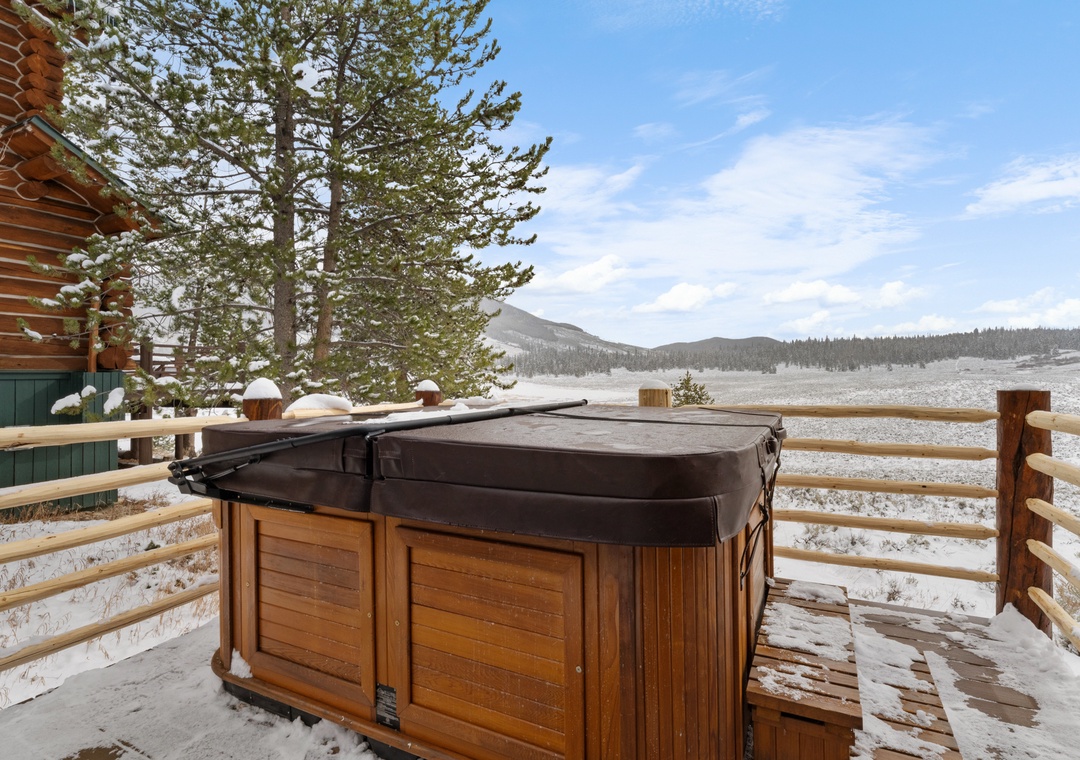 Soak in your private hot tub while taking in breathtaking mountain views—the perfect winter retreat for warming up after snowy adventures.