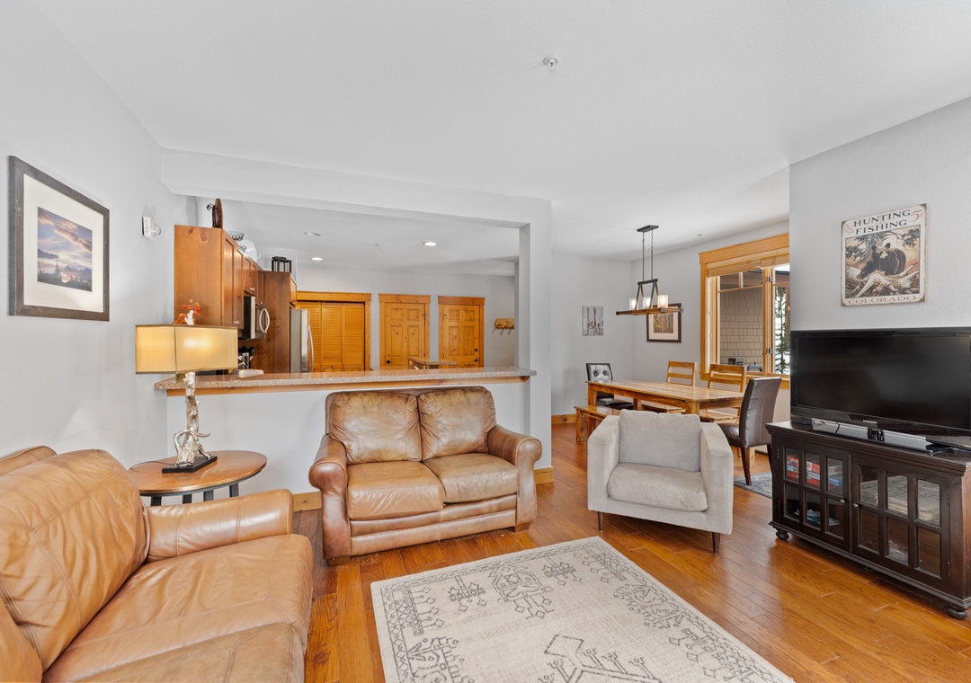 Relax in your elegant living space with rich leather seating, gleaming hardwood floors, and an open kitchen perfect for entertaining.