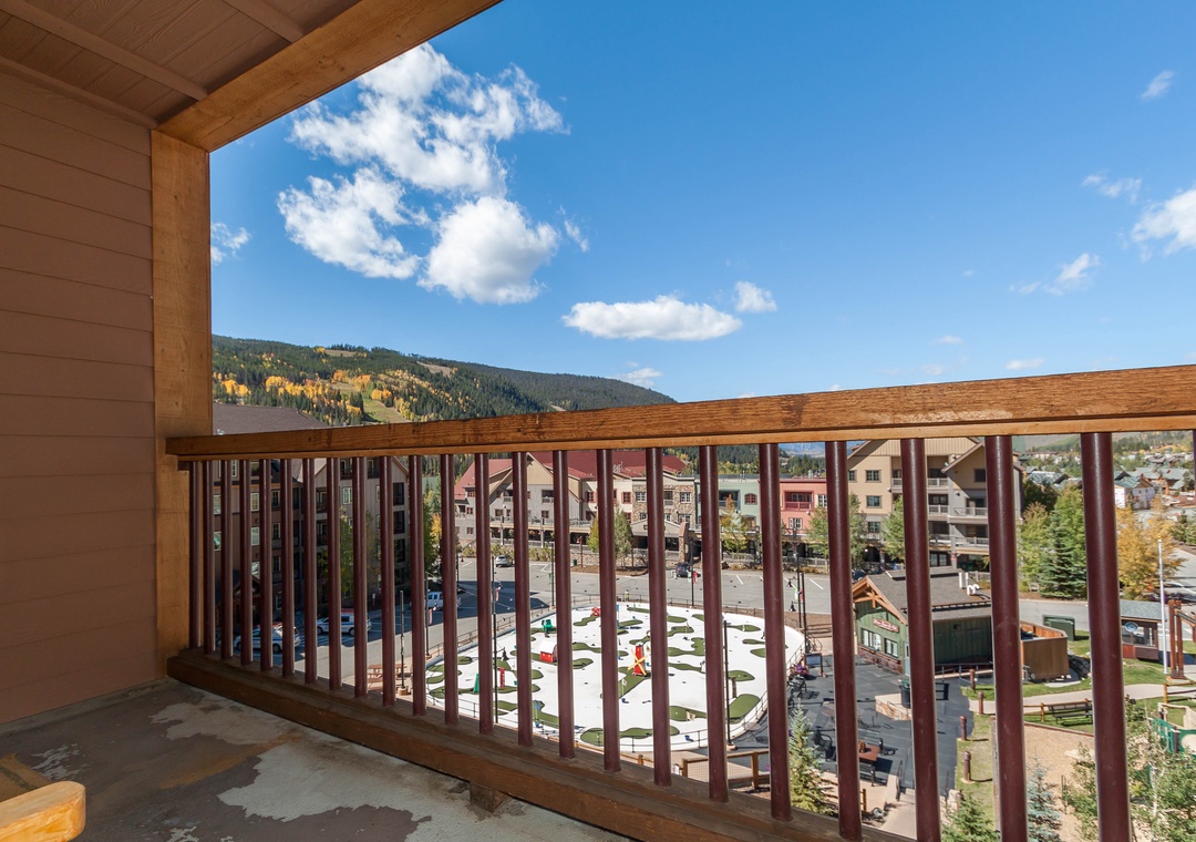 Stunning mountain and village views from your private balcony, with golden autumn foliage creating a picturesque backdrop for your stay.