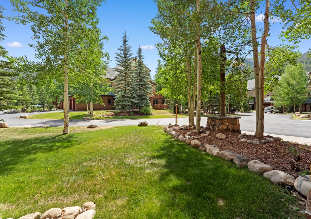 Beautiful mountain neighborhood with mature trees, manicured landscaping, and peaceful residential streets creating a serene alpine setting.