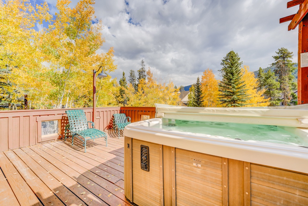 Soak in your private hot tub while golden autumn leaves create a stunning backdrop for ultimate relaxation on this spacious deck.