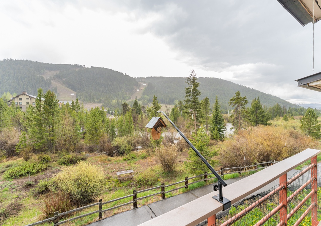 Stunning mountain views stretch across forested hills from this peaceful balcony, perfect for morning coffee and evening relaxation.