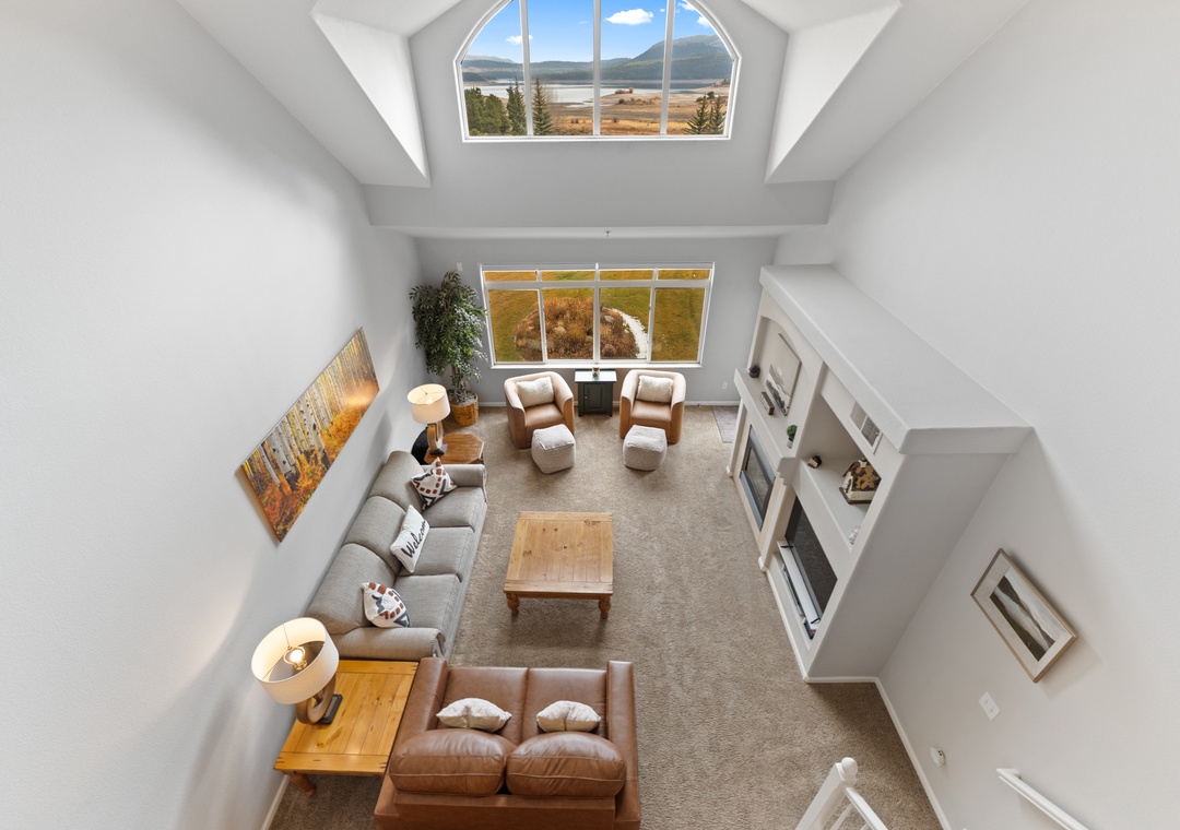Settle into this bright, open living space where panoramic windows frame stunning mountain views, creating your perfect retreat.