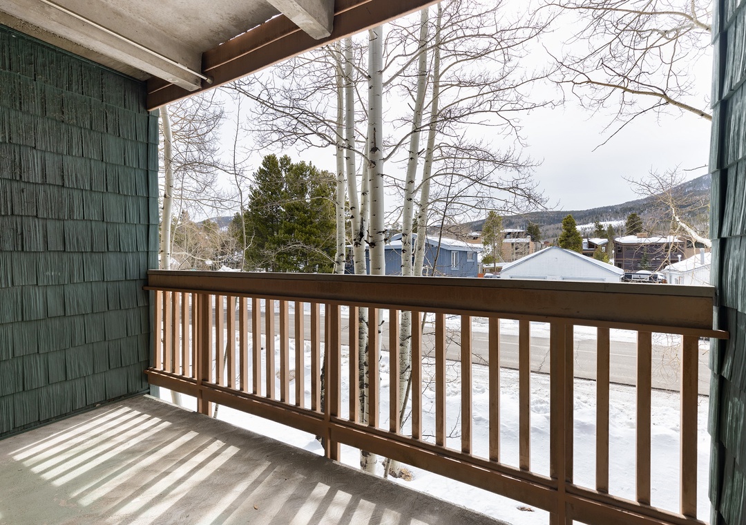 Step onto your private balcony for peaceful mountain views and fresh alpine air, with towering aspens framing winter's quiet beauty.
