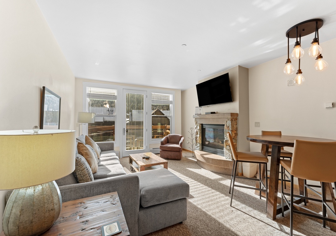Unwind in your stylish living space with plush seating, crackling fireplace, and modern entertainment - perfect for cozy evenings after mountain adventures.