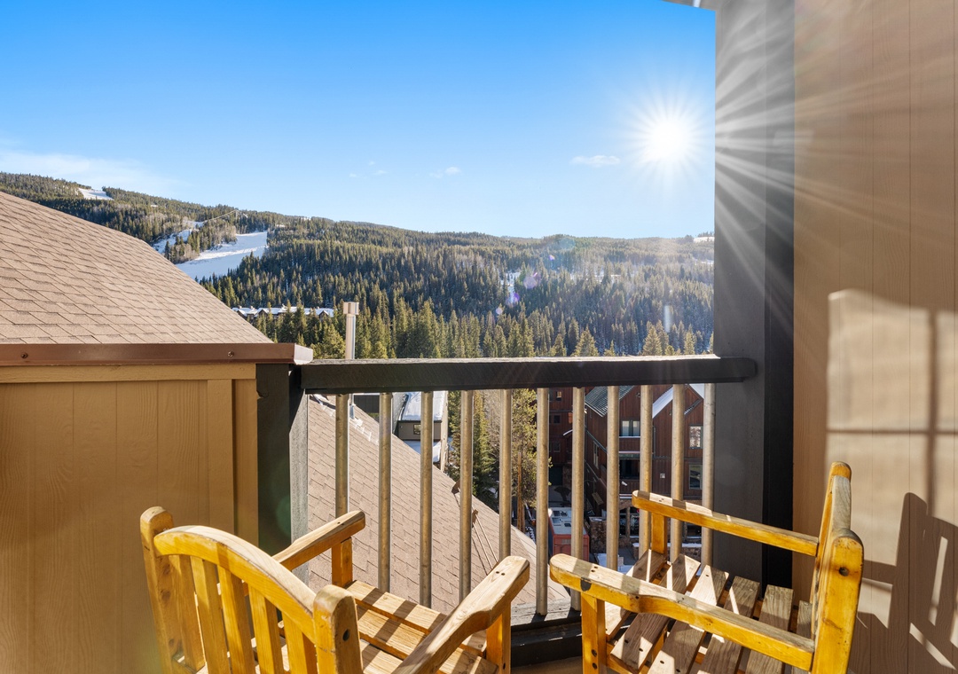 Breathe in crisp mountain air from your private balcony, where wooden chairs await your morning coffee moments against stunning alpine vistas.