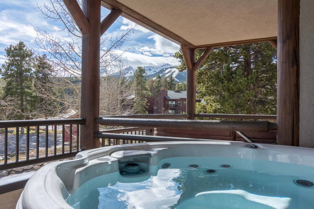 Soak in your private hot tub while enjoying breathtaking mountain views from this covered terrace.