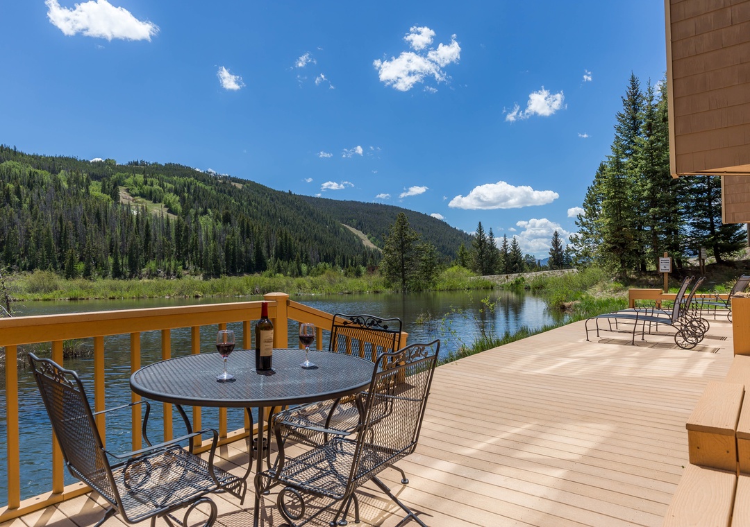Stunning riverside deck with mountain views and dining setup - perfect for memorable meals surrounded by Colorado's natural beauty.