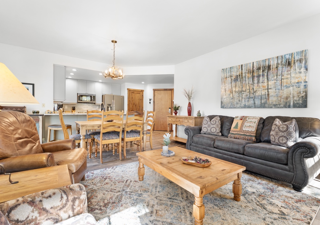 Settle into this inviting open living space where your group can gather comfortably. Rich leather seating, a generous coffee table, and a welcoming dining area create the perfect setting for relaxed conversations and shared meals.