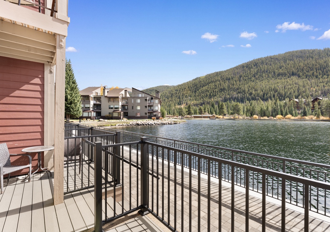 This lakeside property sits along a quiet, forested mountain setting. Neighboring buildings and boardwalk areas complete the serene, natural environment of the resort community.